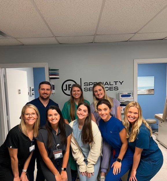 Dermatology Residents Drs. Sarah Fillingim (left), Cody Estep (top left), and Sally McClung (top middle) volunteer with UMMC Medical Students at the Jackson Free Clinic.